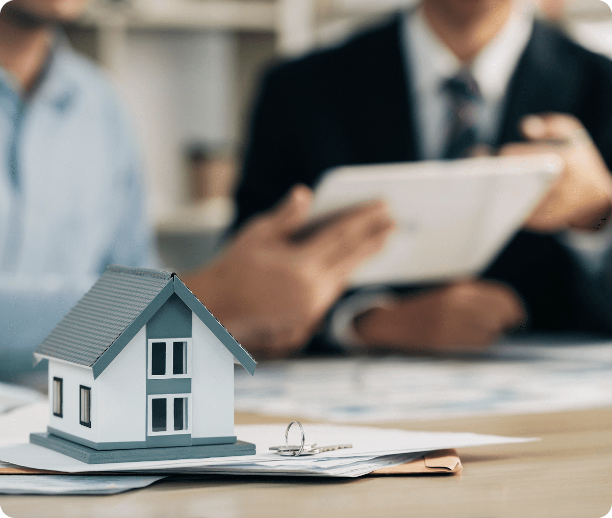 Real estate discussion with house model